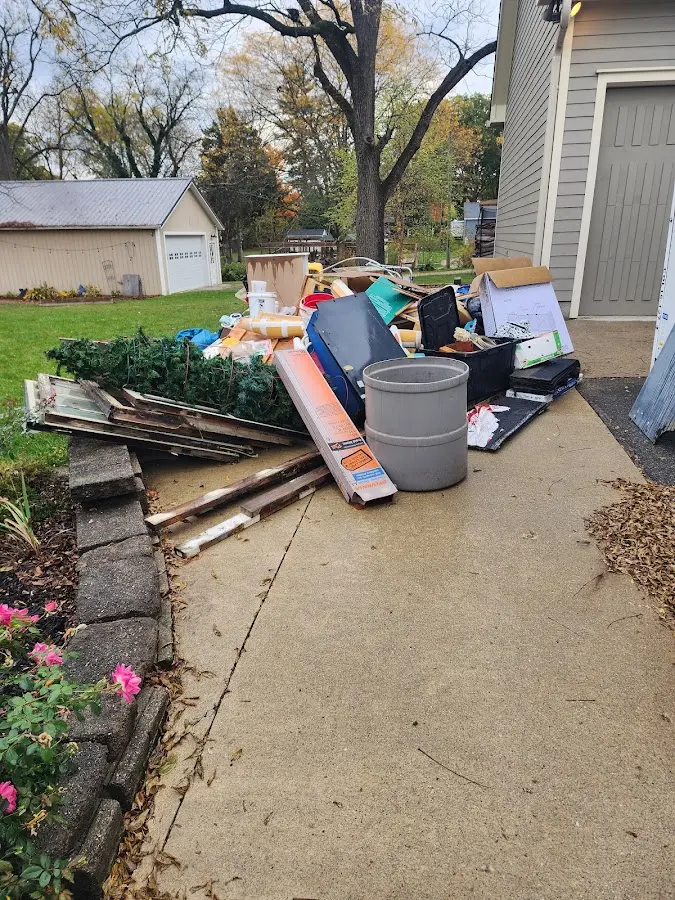 Dumpster being loaded with debris for 3 Yard Dumpster Rental in Hereford